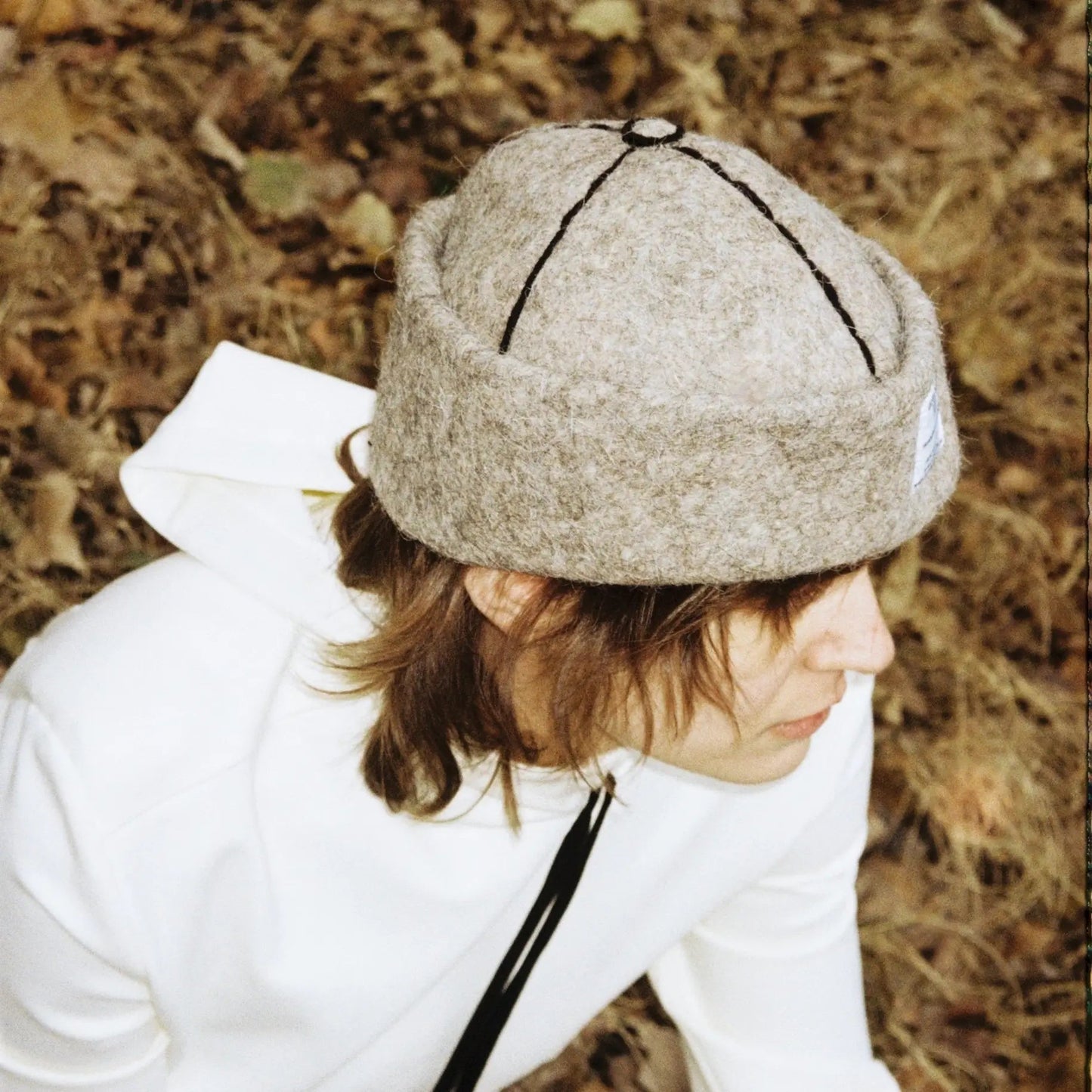 Model pairing Ash wool felt hat with a sleek, contemporary outfit