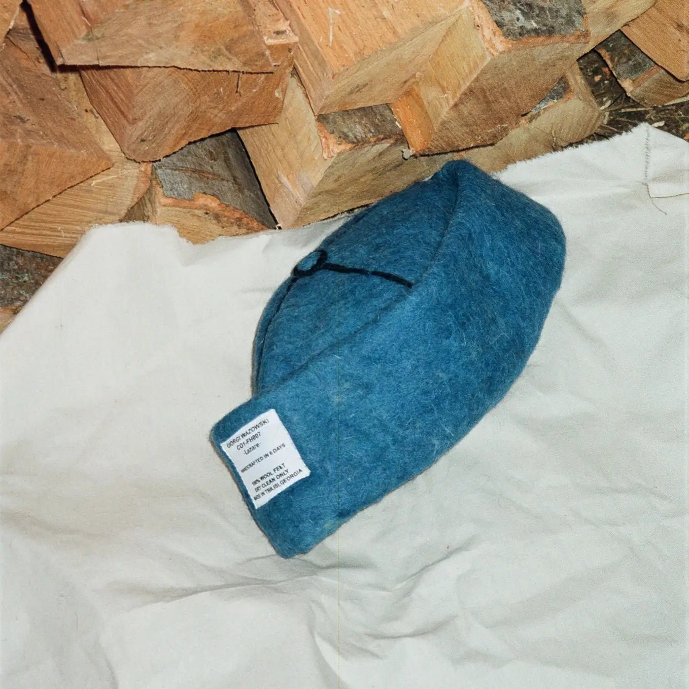 Folded Azure wool felt hat, showcasing vibrant blue tones and fine wool texture