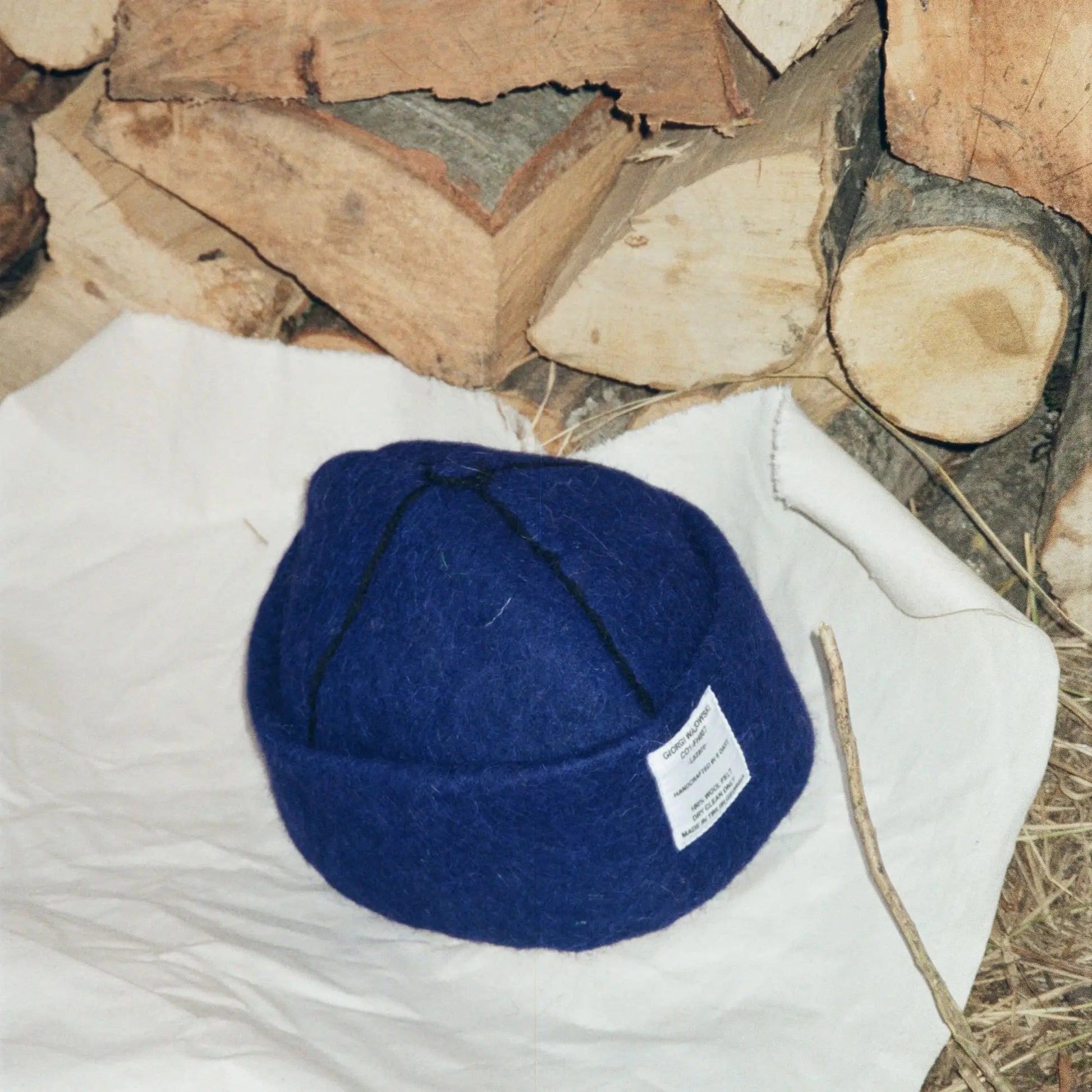 Close-up of Denim wool felt material and black stitching details