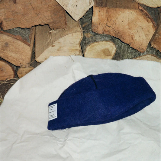 Folded Denim wool felt hat, highlighting its rich blue tones and soft wool texture.