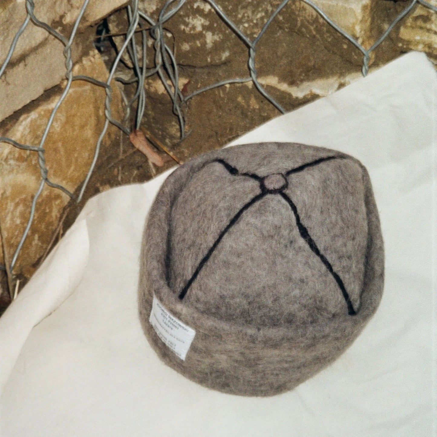 Close-up of Dust hat’s wool texture and intricate stitching detail