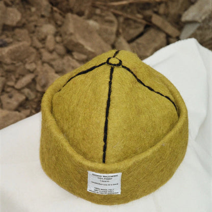 Detailed view of Mustard hat’s stitching and label by Giorgi Wazowski