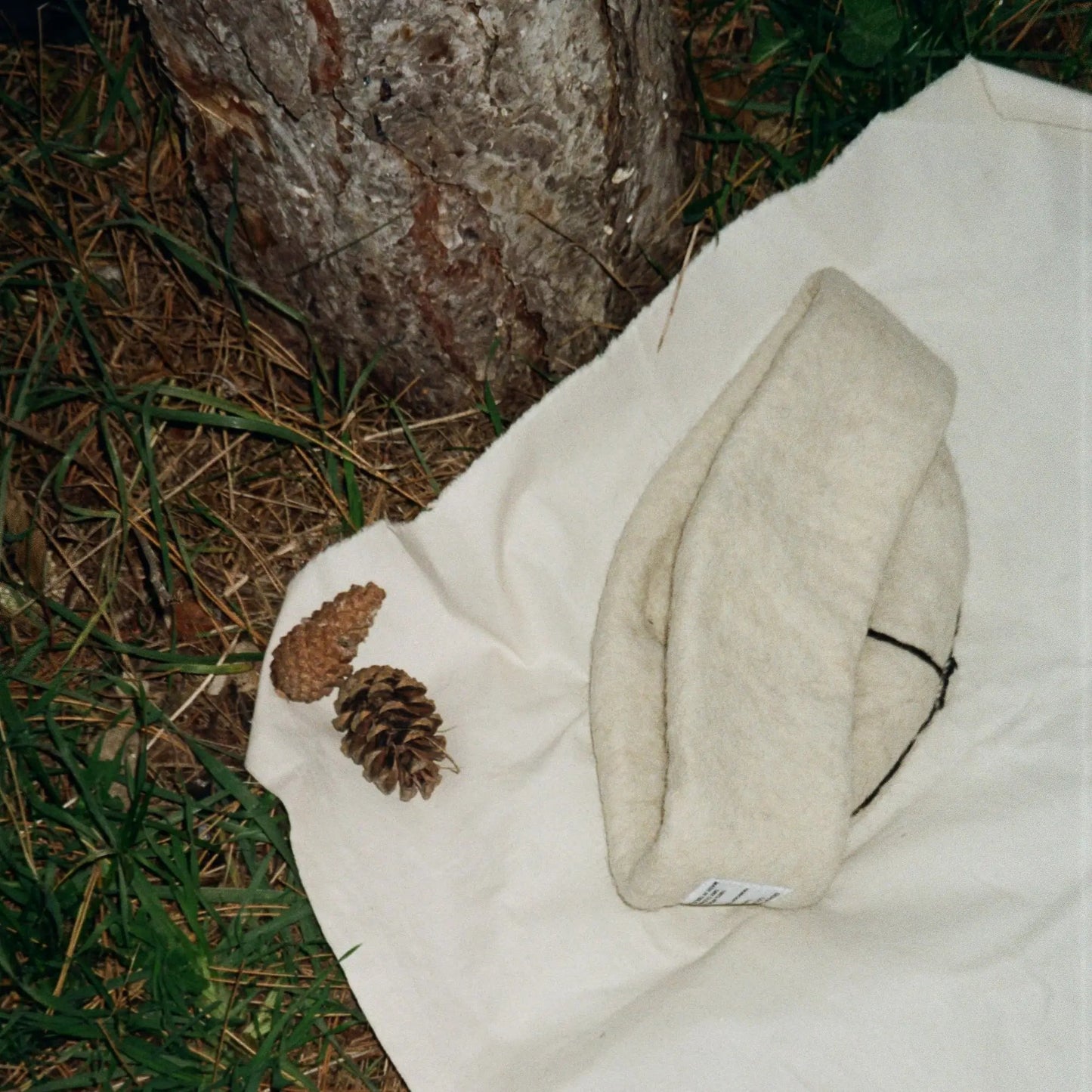 Folded Snow White wool felt hat, highlighting its clean design and soft wool material