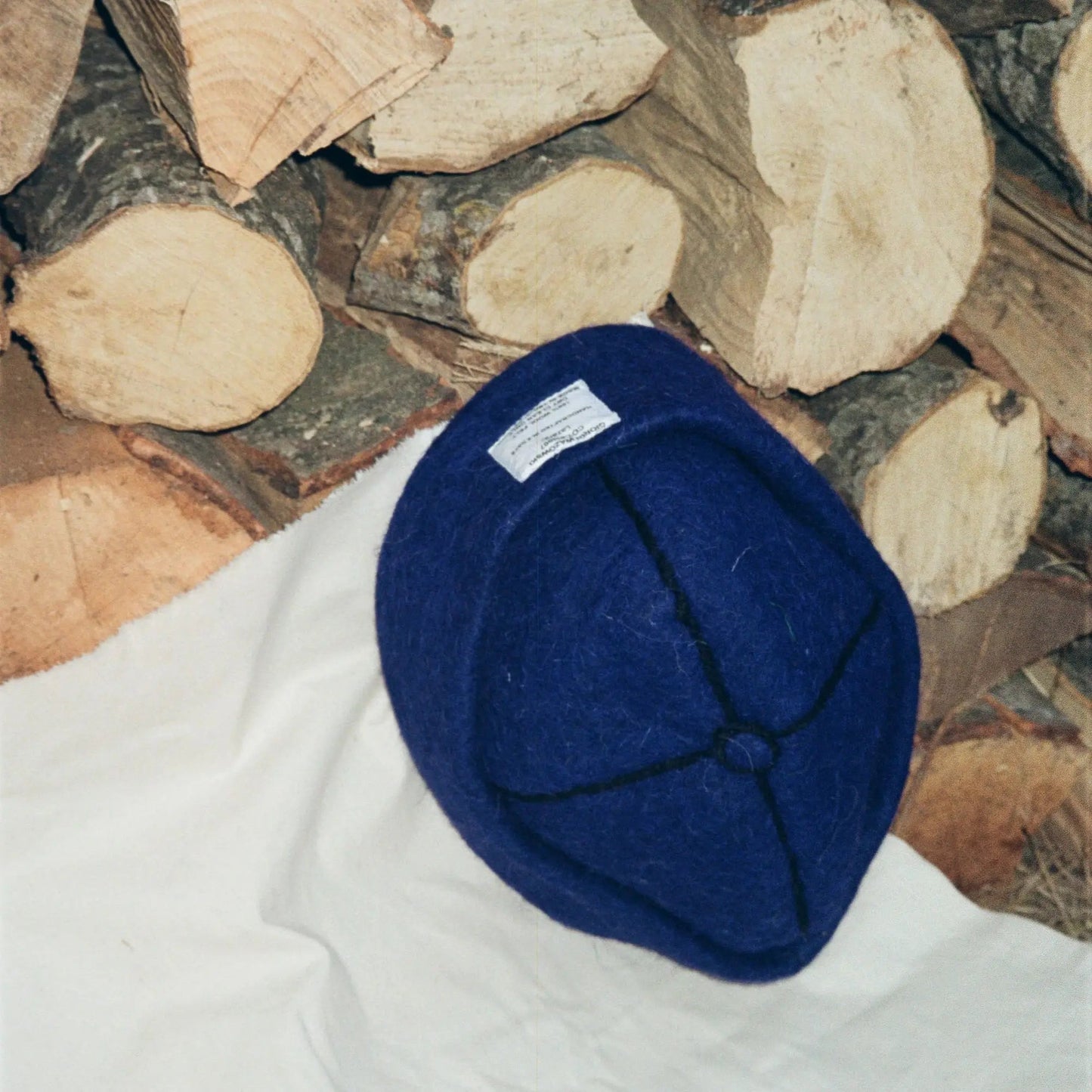Detailed view of Denim hat’s stitching and wool label by Giorgi Wazowski