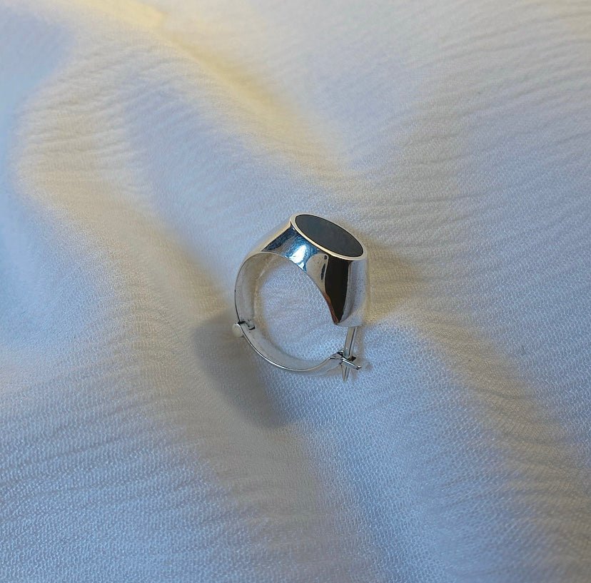 MURMAN convertible earring-ring in sterling silver and black enamel, merging minimalist edge with sculptural artistry.