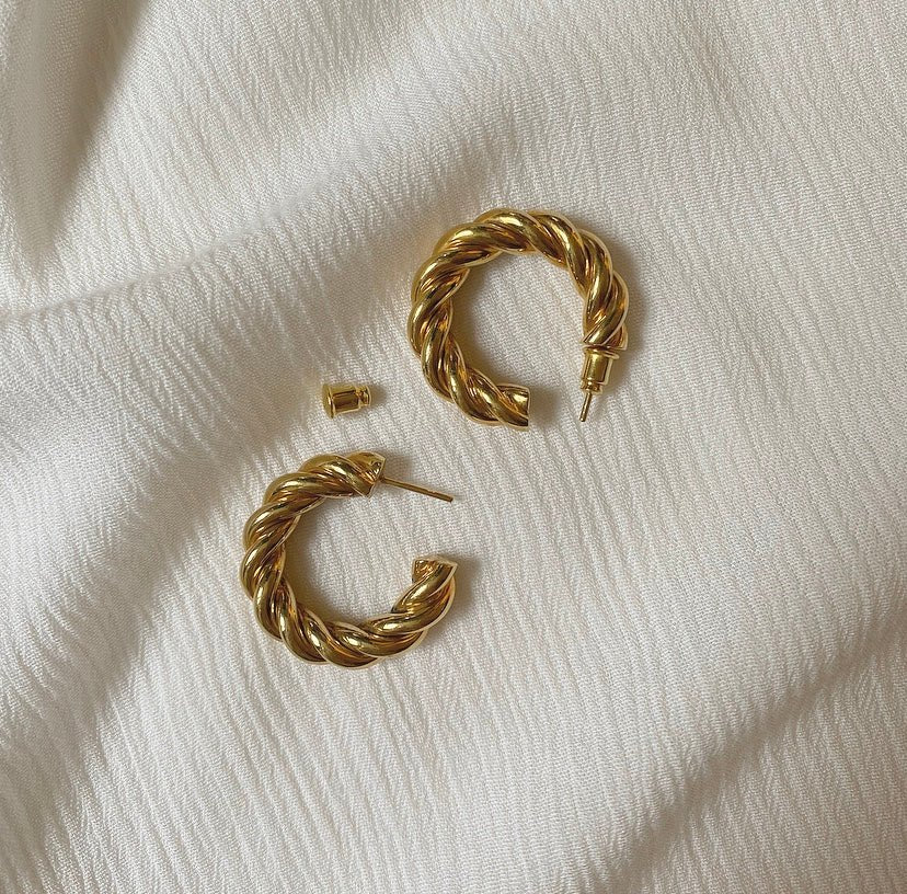 NURBANU gold hoops styled in a flat lay, perfect for elevating casual outfits or evening looks.