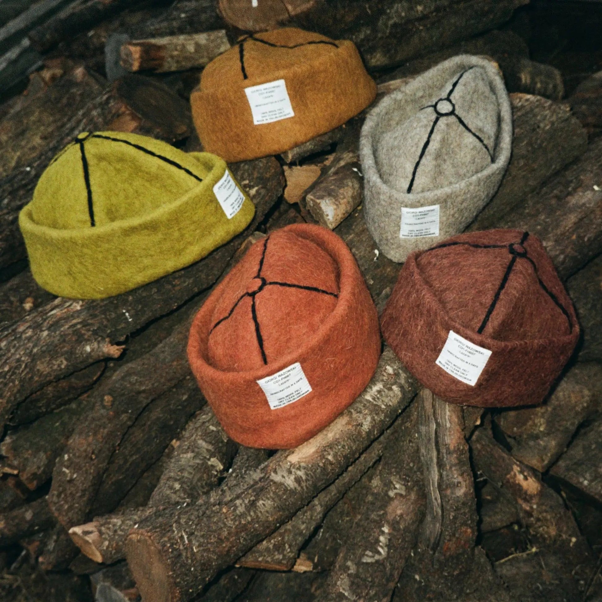 A blend of earthy tones—Tobacco, Mocha, Ash, and Mustard wool felt hats—crafted from natural wool with detailed stitching.