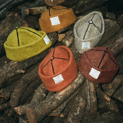 A blend of earthy tones—Tobacco, Mocha, Ash, and Mustard wool felt hats—crafted from natural wool with detailed stitching.